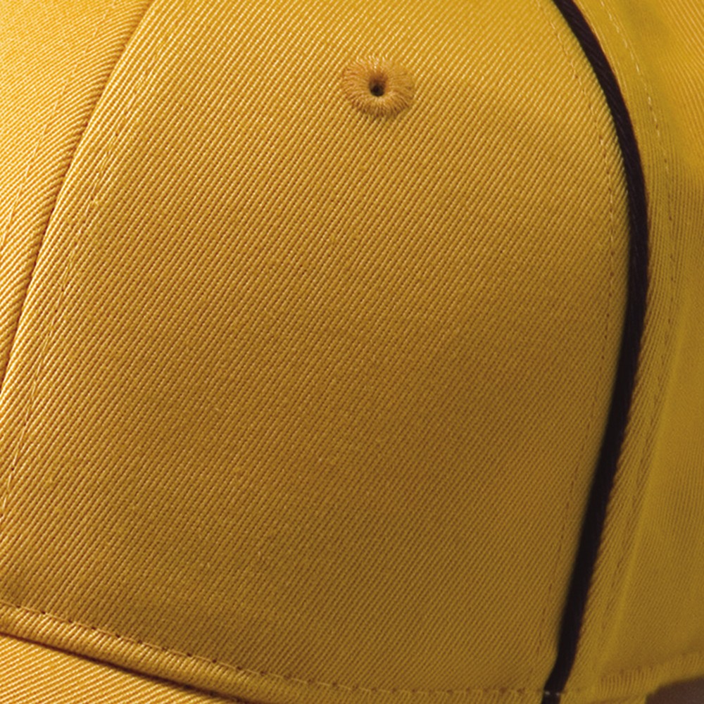 Close crop of a metal eyelet set into a crown panel seam